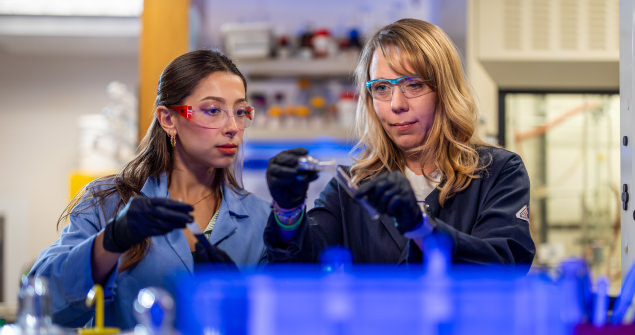Two people working in a lab.