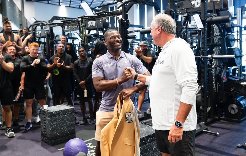 LT giving jacket to Coach Dykes